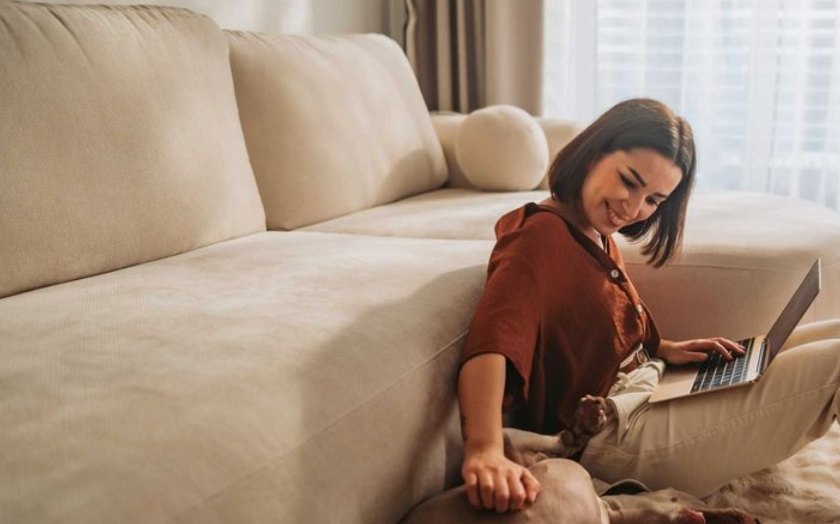Homeowner relaxing at home with a laptop